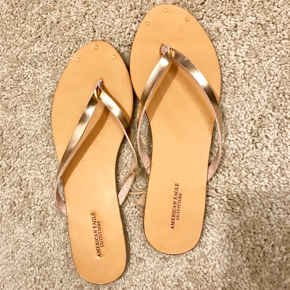 American Eagle rose gold flip flops